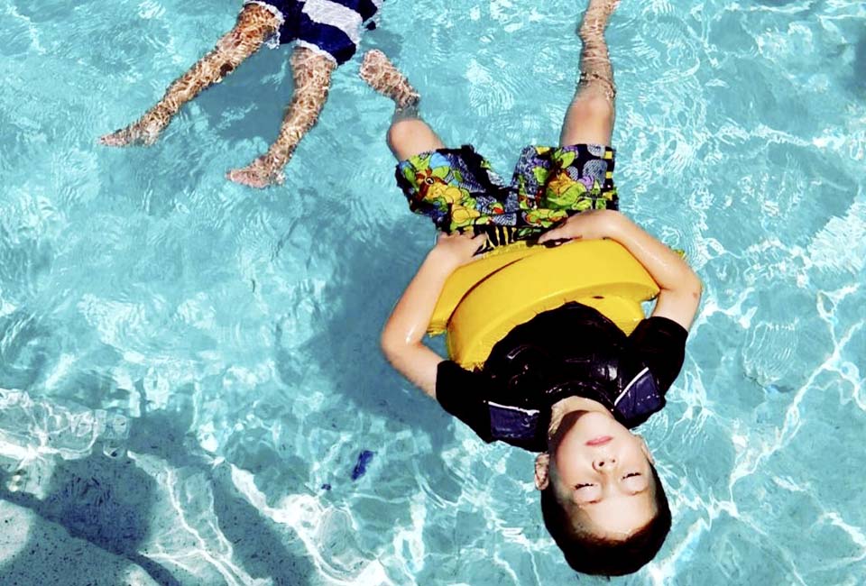 Boy floating in pool
